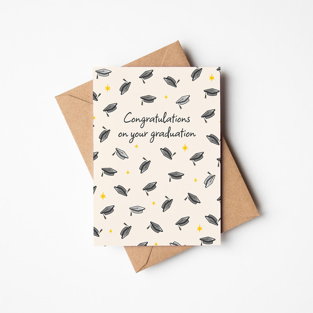 unique graduation card featuring illustrated mortarboards and a 'congratulations on your graduation' message with a kraft brown recycled envelope on a white background