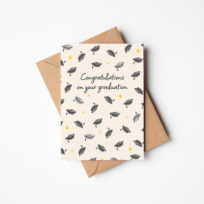 unique graduation card featuring illustrated mortarboards and a 'congratulations on your graduation' message with a kraft brown recycled envelope on a white background