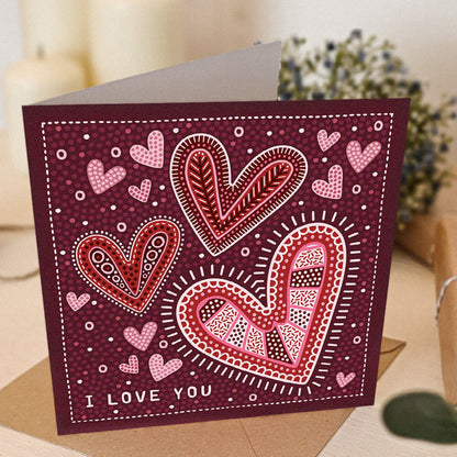 red romantic anniversary card with i love you message and illustrated hearts supplied with a recycled kraft brown envelope