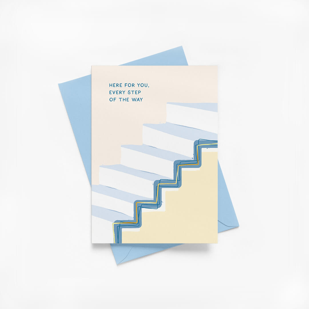 Greeting card with blue staircase illustration and gold foil details with blue envelope on a white background