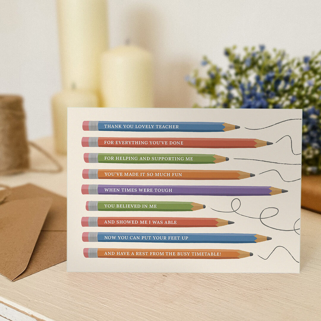 unique thank you teacher card featuring illustrated pencils sat on a cream dresser with candles and plants in the background