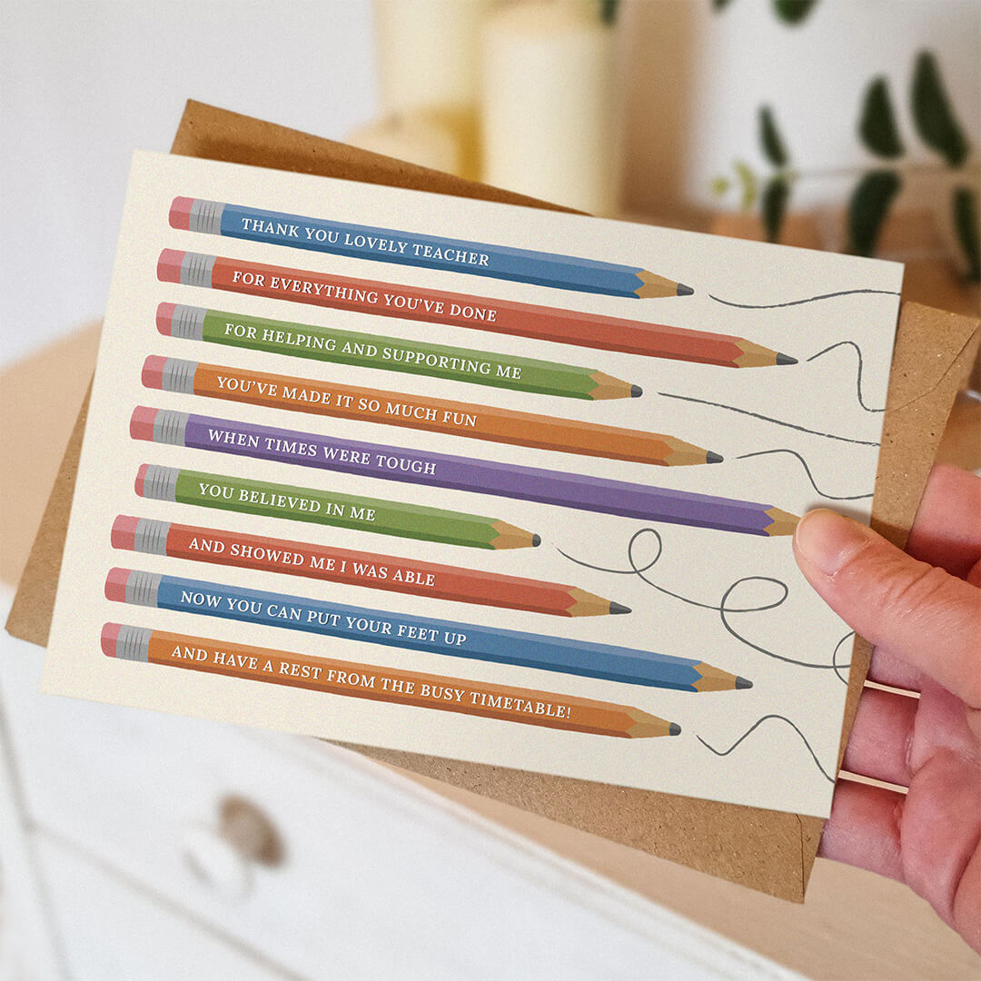 hand holding unique thank you teacher card featuring pencil illustrations and a thoughtful rhyming verse with a blurred background