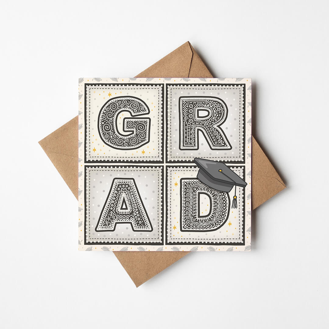 unique graduation card with 'GRAD' message and hat illustration with kraft brown recycled envelope on white background
