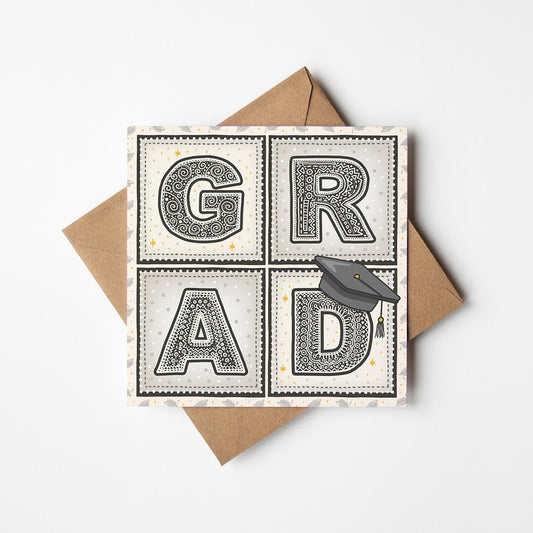 unique graduation card with 'GRAD' message and hat illustration with kraft brown recycled envelope on white background