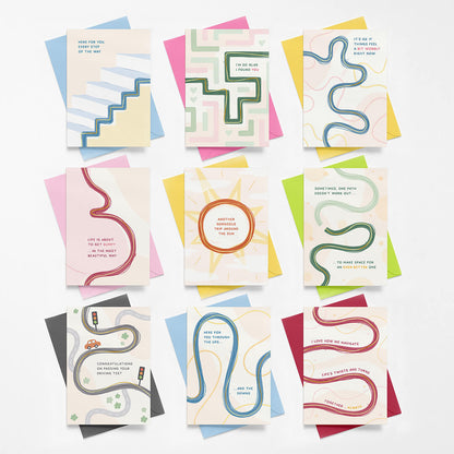 Collection of colourful greeting cards with abstract designs and supportive messages on a white background