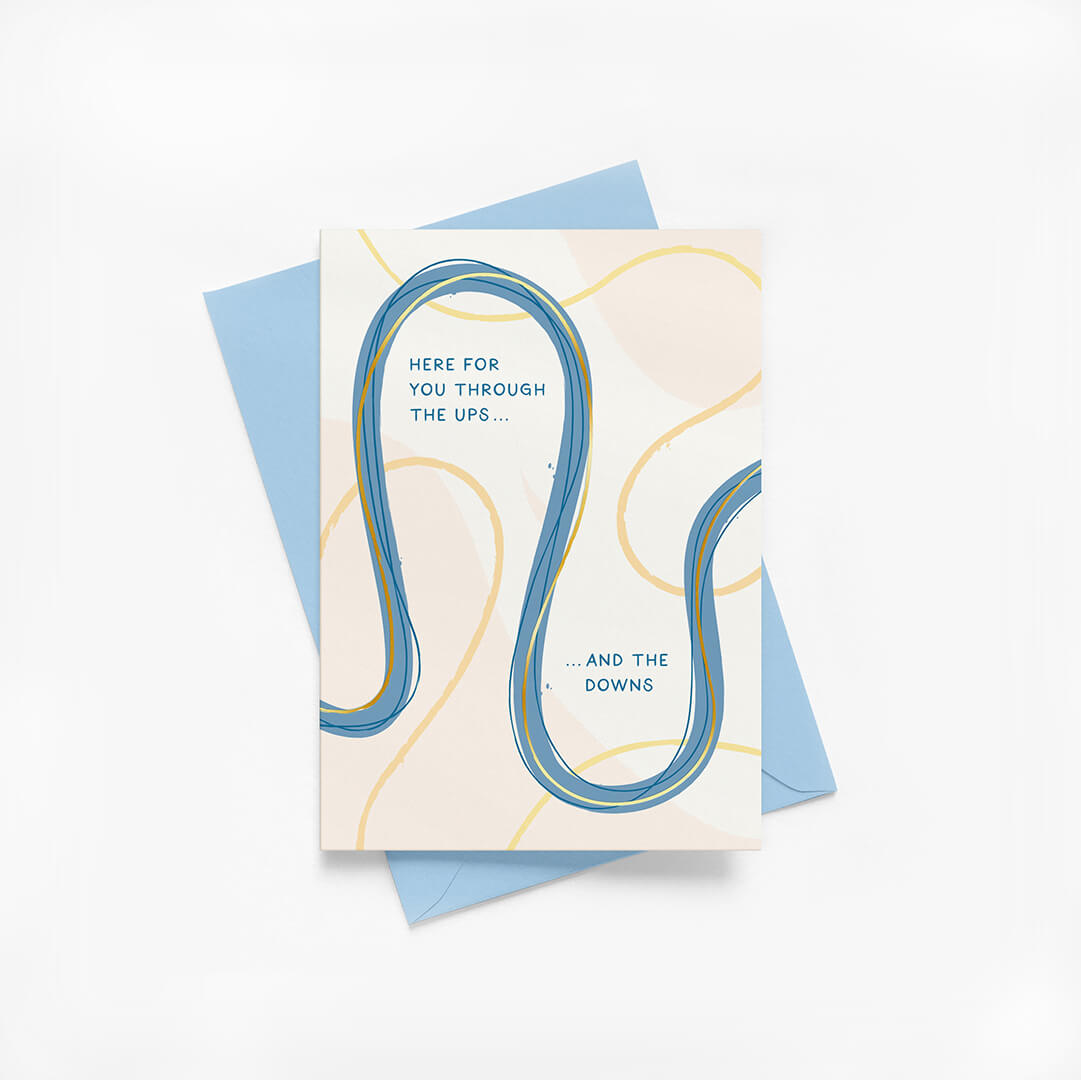 Friendship greeting card with abstract design and supportive message with blue envelope on a white background