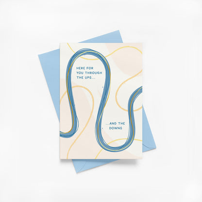 Friendship greeting card with abstract design and supportive message with blue envelope on a white background