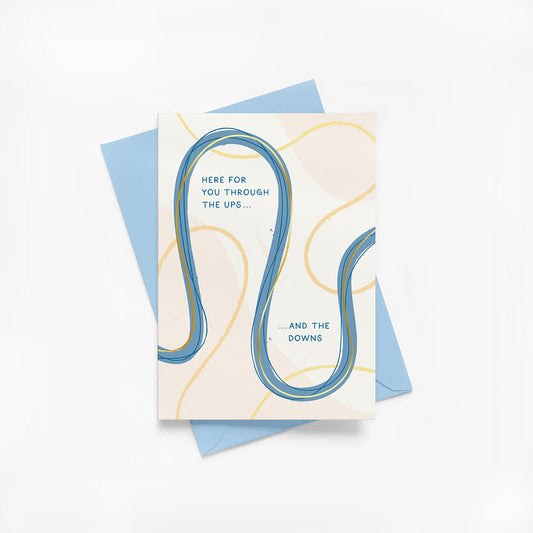 Friendship greeting card with abstract design and supportive message with blue envelope on a white background
