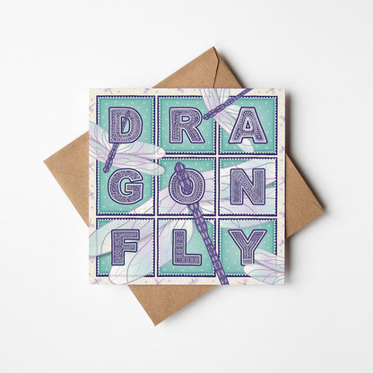 Purple and turquoise dragonfly greeting card with 'Dragonfly' text and dragonfly illustrations on a white background