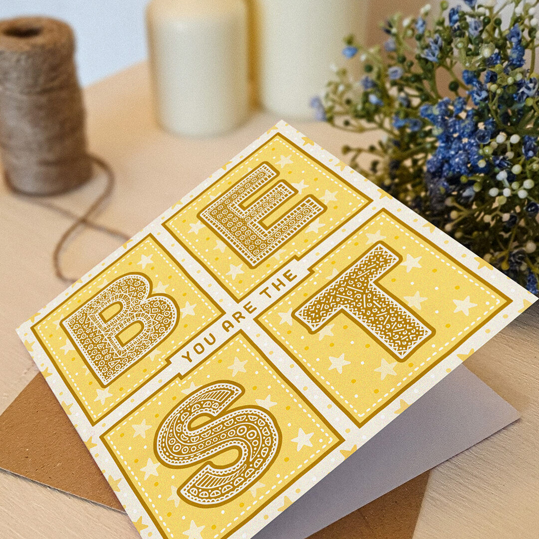 yellow starry thank you card with you are the best message led on a cream dresser with plants and candles in the background